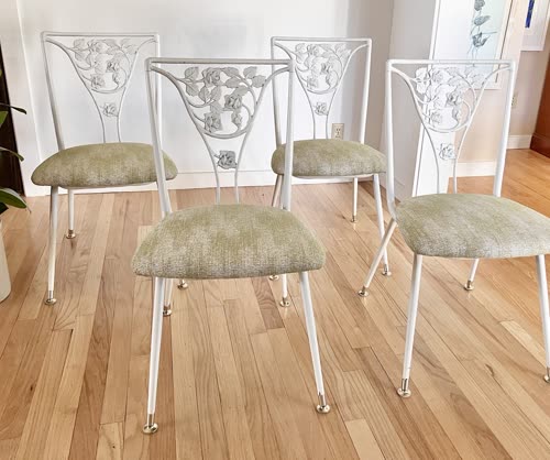 Set of four white metal chairs with rose motif backs and sage green seats