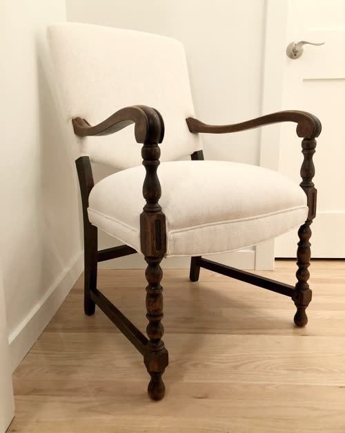 Antique armchair with turned wood legs reupholstered in cream linen